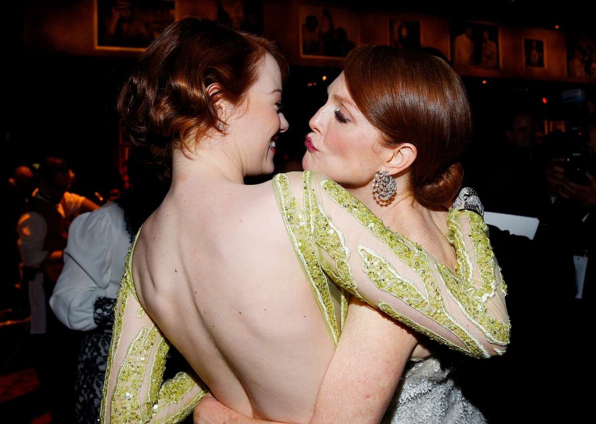 Actresses Emma Stone (L) and Julianne Moore attend the 87th Annual Academy Awards Governors Ball at Hollywood & Highland Center on February 22, 2015 in Hollywood, California.