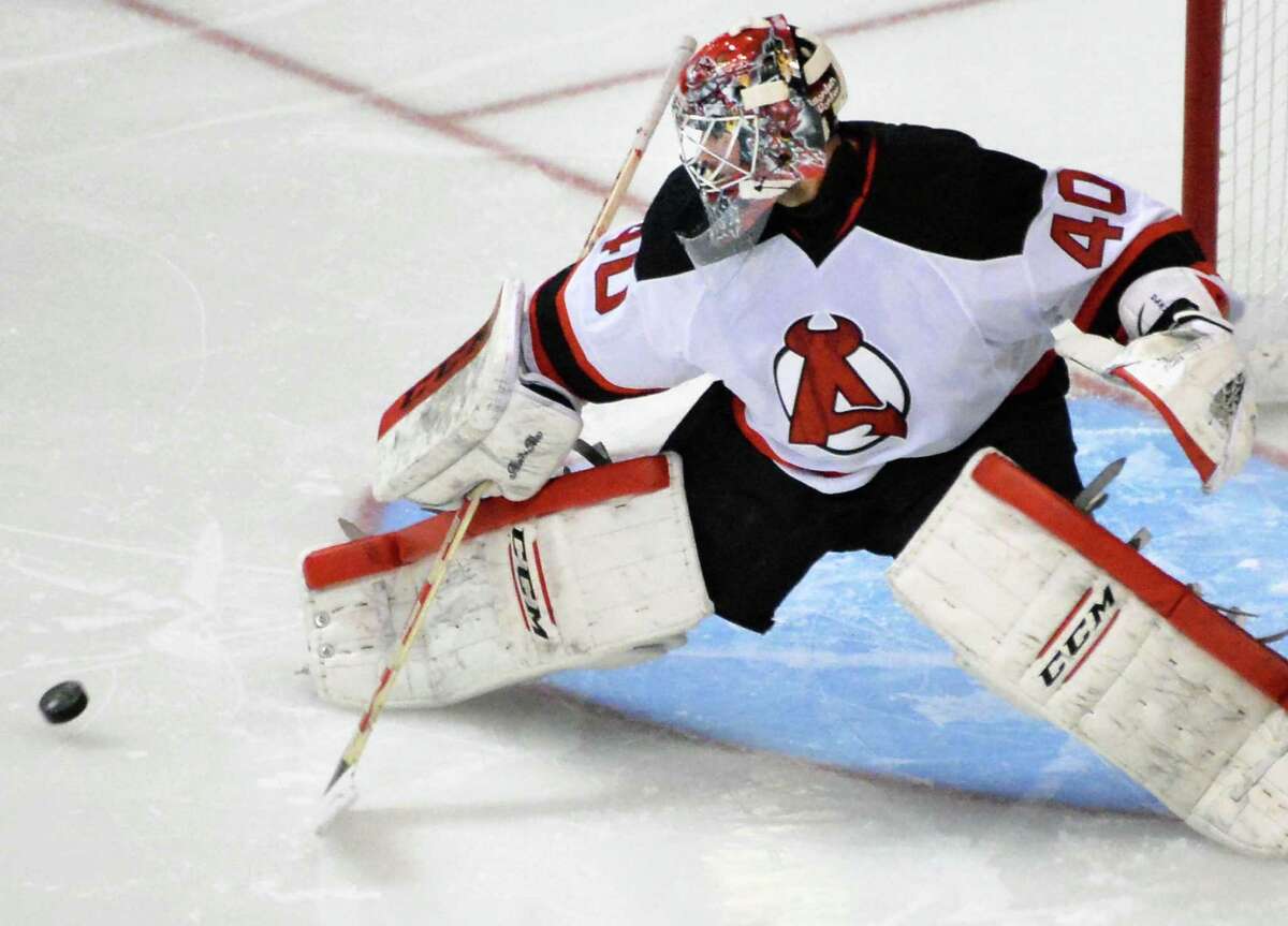 Albany Devils goalie Yann Danis stops a shot on goal by the Portland Pirates during Saturday's game at the Times Union Center Oct. 24, 2015 in Albany, NY. (John Carl D'Annibale / Times Union)