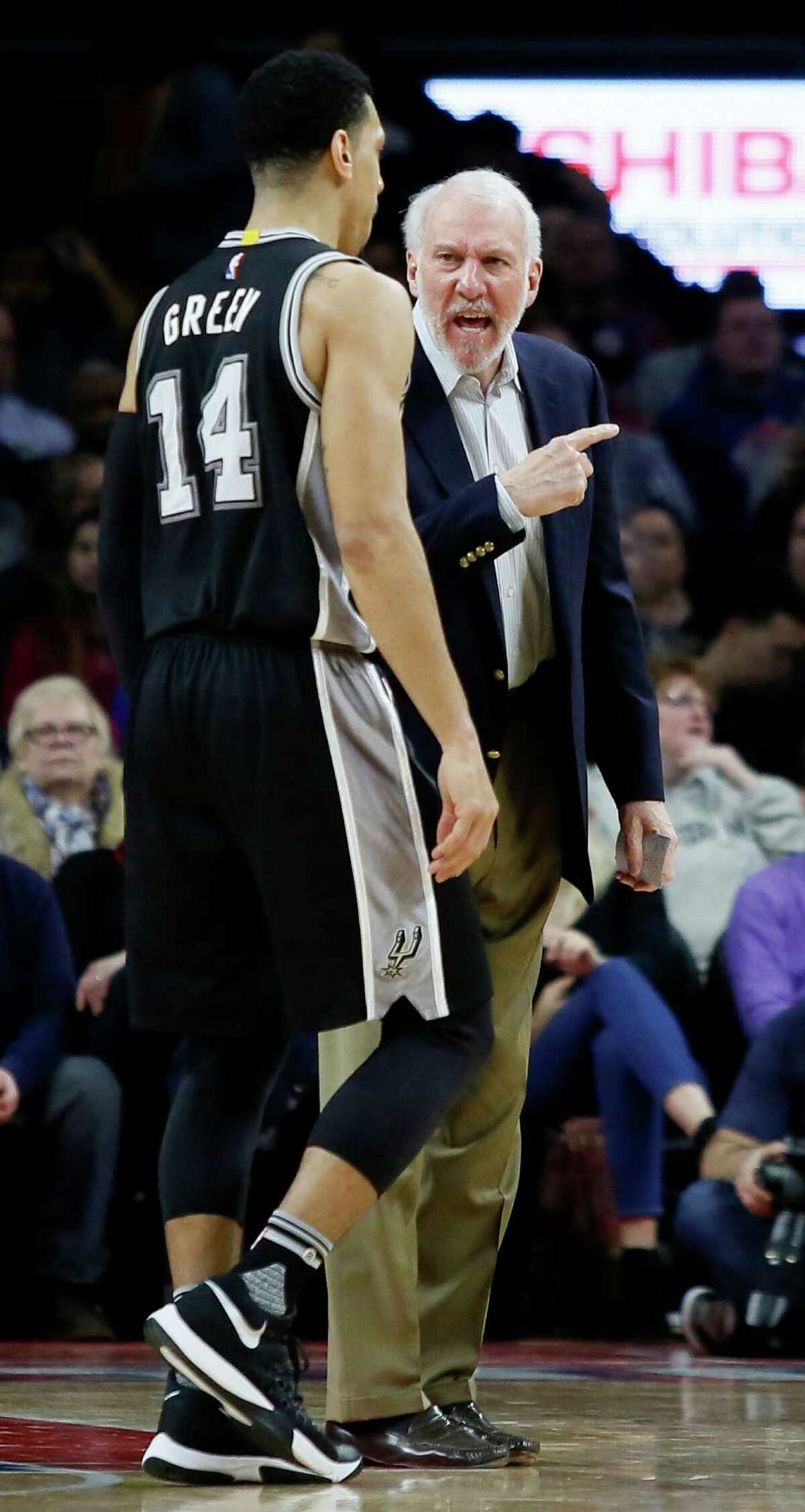 San Antonio Spurs coach Gregg Popovich, right, has some words for guard Danny Green (14) after a timeout was called during the fourth quarter of an NBA basketball game against the Detroit Pistons, Tuesday, Jan. 12, 2016, in Auburn Hills, Mich. (AP Photo/Duane Burleson)