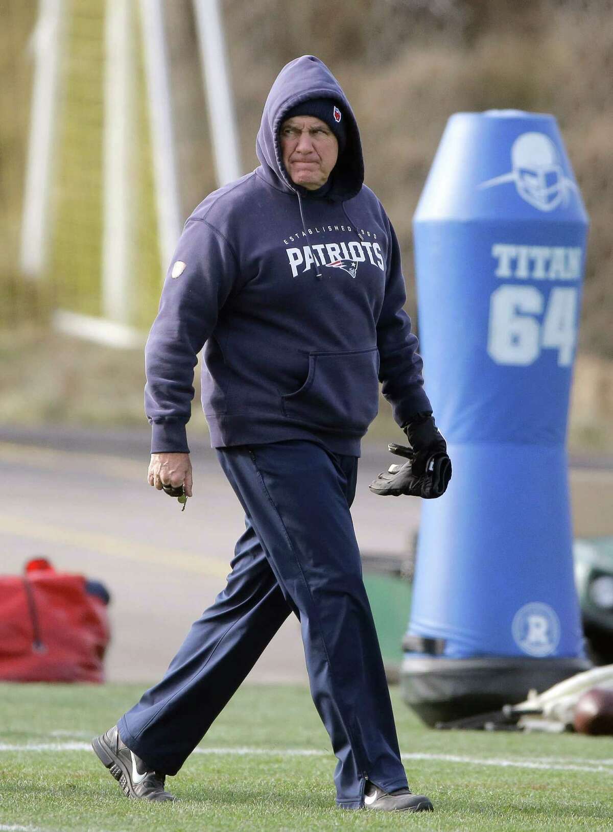 New England Patriots head coach Bill Belichick walks on the field during an NFL football practice, Tuesday, Jan. 12, 2016, in Foxborough, Mass. The Patriots are to host the Kansas City Chiefs in an NFL divisional playoff game Jan. 16, 2016, in Foxborough. (AP Photo/Steven Senne) ORG XMIT: MASR108