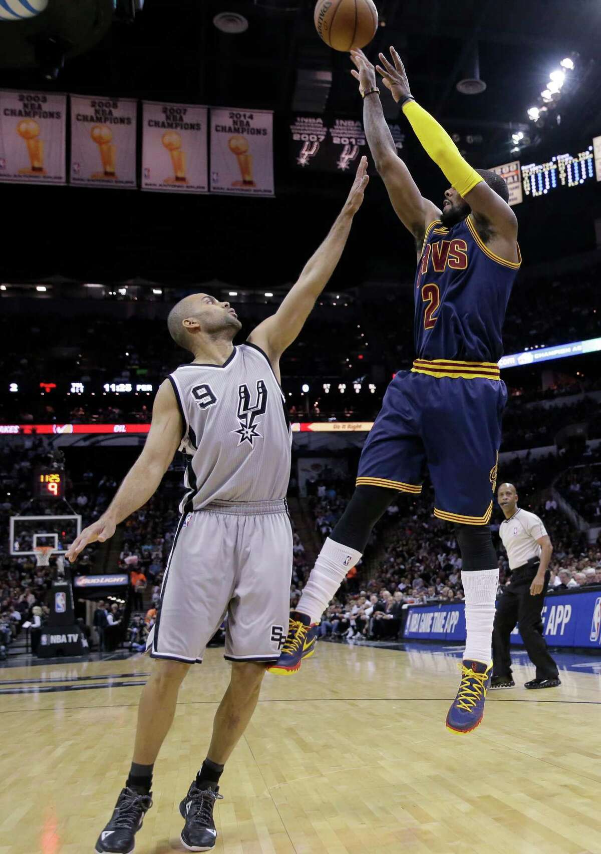 Cavaliers’ Kyrie Irving shoots over the Spurs’ Tony Parker during the first half on March 12, 2015, in San Antonio.