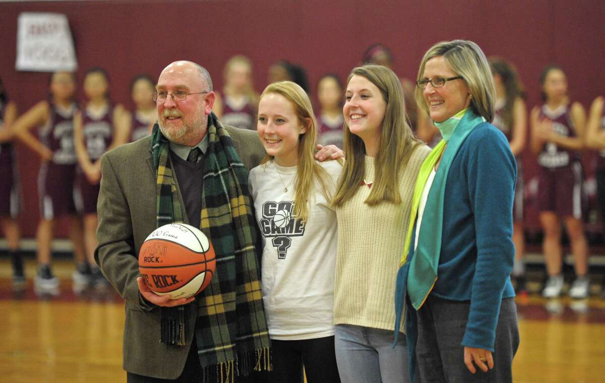 Wooster School girls varsity basketball coach David McNutt was presented a game ball celebrating his 1,000th career varsity basketball game on Wednesday afternoon. Celebrating with him were his his daughters Jamie and Kate McNutt, and wife Janet Jochem, right. With a career record of 780-220, with todays victory, McNutt, who started teaching and coaching at Wooster in 1992, led the Wooster Generals girls varsity basketball team to 22 New England Tournaments, 16 league titles, 6 undefeated seasons and the New England Class E Championship the last two seasons. Wednesday, January 13, 2016, in Danbury, Conn.