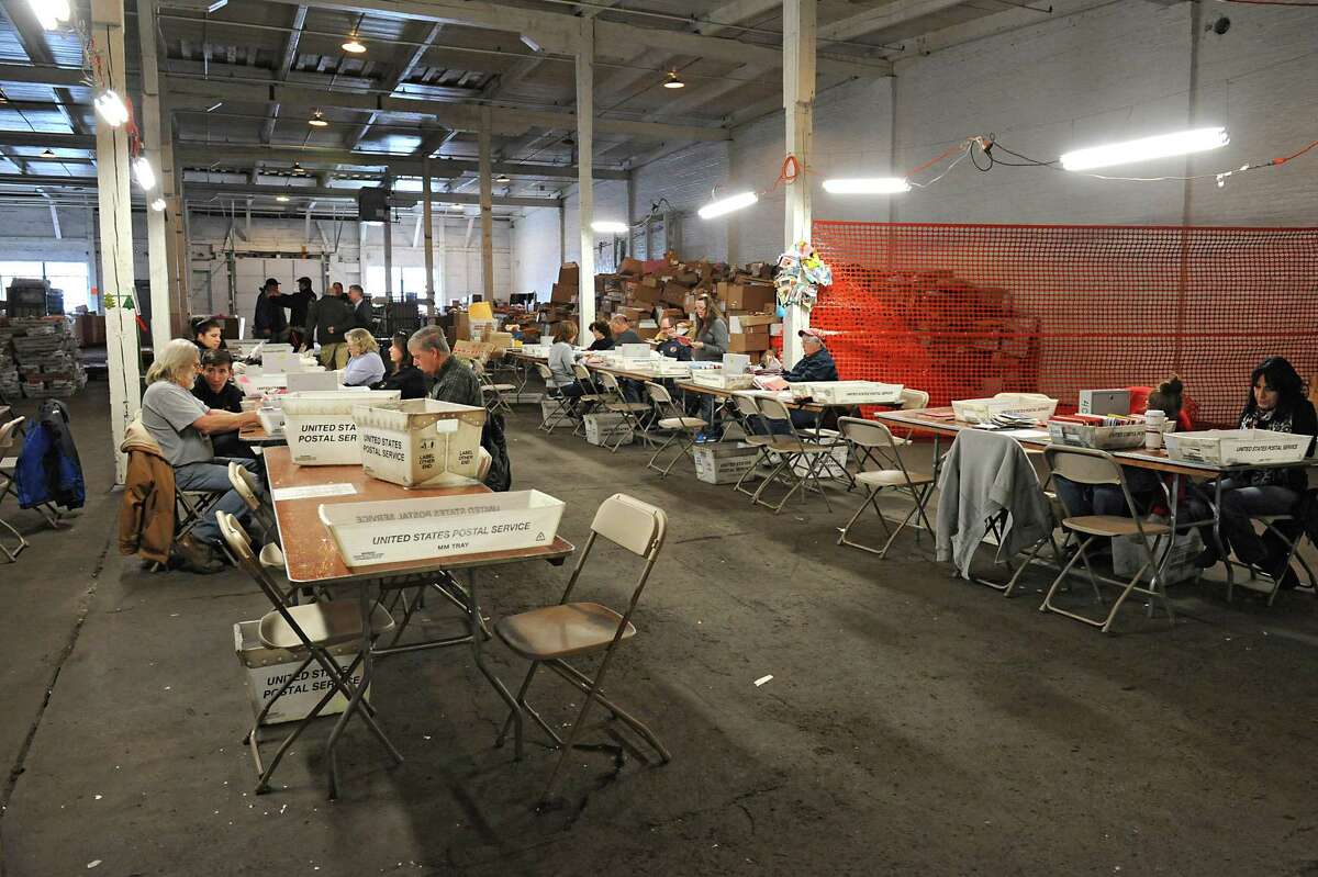 Volunteers open thousands of letters and parcels at Safyre's Angels Headquarters located at the Rotterdam Industrial Park on Wednesday Jan. 13, 2016 in Albany, N.Y. Volunteers to help open the letters are needed. (Lori Van Buren / Times Union)