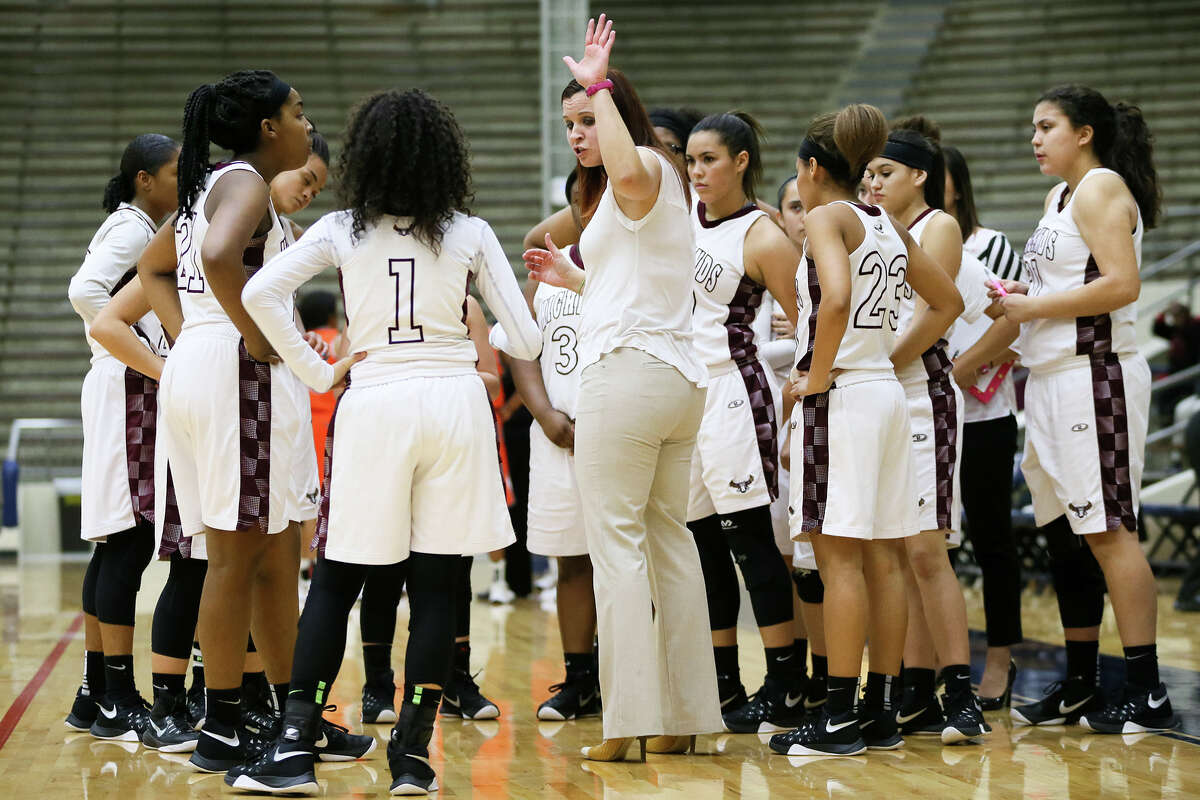 Highlands' coach Adrianna Wiatrek talks to the Lady Owls during a time out in their District 28-5A game against Burbank on Jan. 5. Highlands won, 61-58.