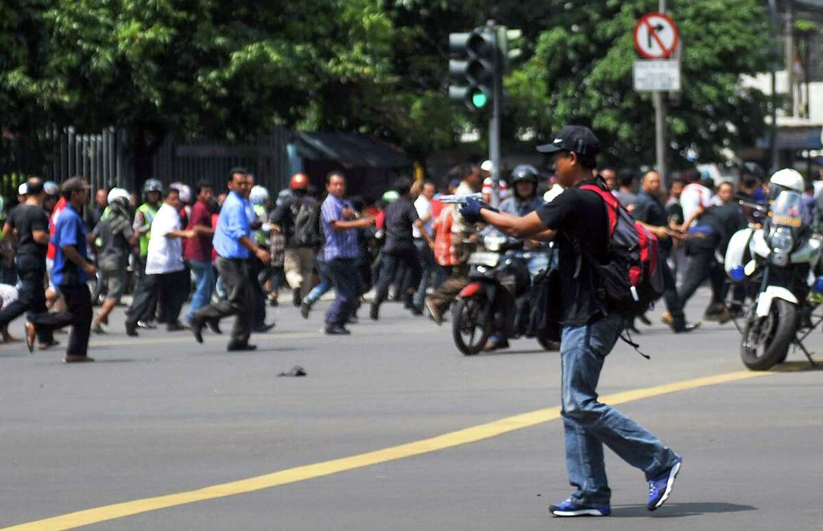 A gunmen points a weapon during deadly attacks in Jakarta, Indonesia.