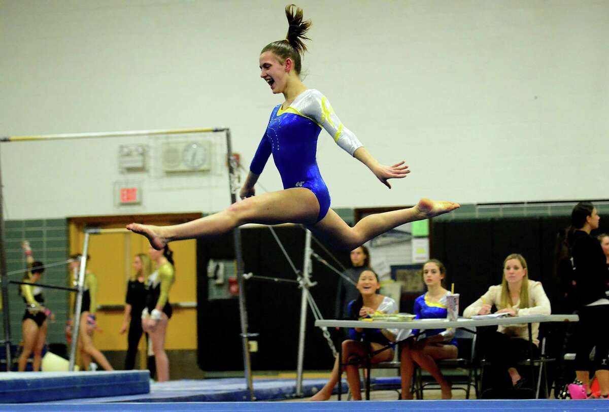 Newtown's Alana O'Donnell competes in the floor routine, during gymnastics competition between Jonathan Law, Daniel Hand and Oxford at Jonathan Law in Milford, Conn., on Thursday Jan. 14, 2015.