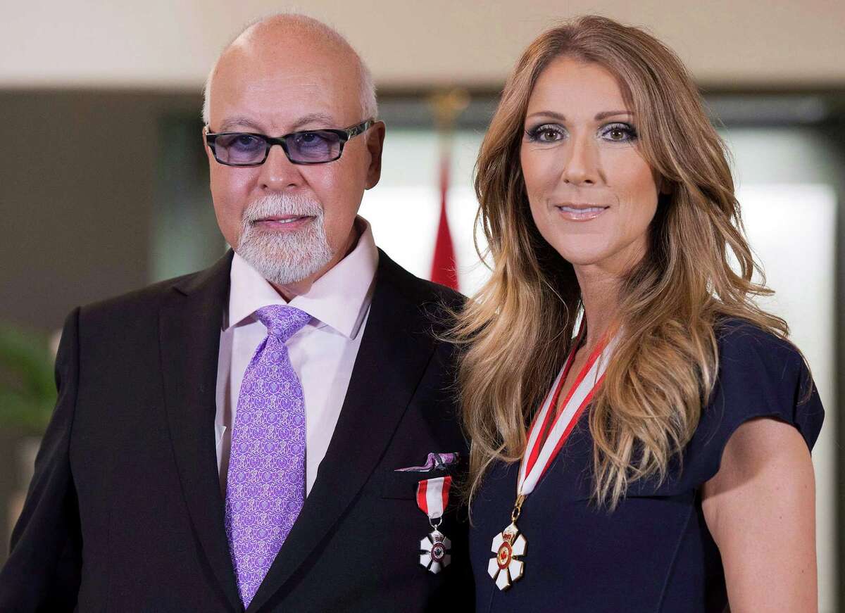 File- This July 26, 2013, file photo shows Canadian music star Celine Dion, right, and husband Rene Angelil posing for photos after being decorated with the Order of Canada in Quebec City. Authorities say Angelil, the husband and manager of Dion, has died in Las Vegas. He was 73 and had battled throat cancer. Clark County Coroner John Fudenberg said his office was notified Thursday, Jan. 14, 2016, of Angelilâs death. (Jacques Boissinot/The Canadian Press, File)