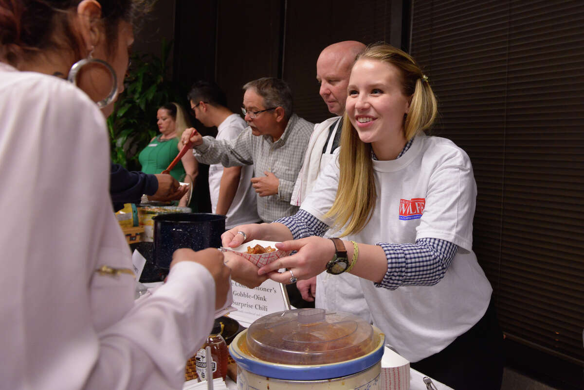 Sydney Wolff passes out chili during a chili cookoff and GOP Presidential Debate watch party Thursday evening at the Bexar County Republican Headquarters.