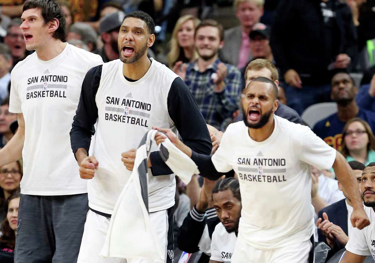 Spurs’ Boban Marjanovic, Tim Duncan, and Patty Mills react after a score during second half action against the Cleveland Cavaliers on Jan. 14, 2016 at the AT&T Center. The Spurs won 99-95.
