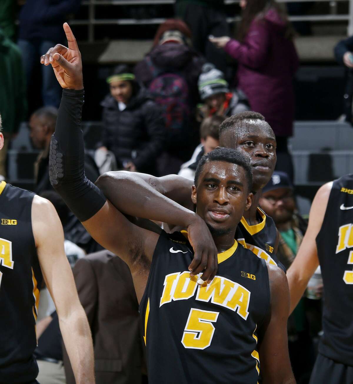 Iowa's Anthony Clemmons (5) and Peter Jok celebrate following a 76-59 win over Michigan State in an NCAA college basketball game Thursday, Jan. 14, 2016, in East Lansing, Mich. (AP Photo/Al Goldis)