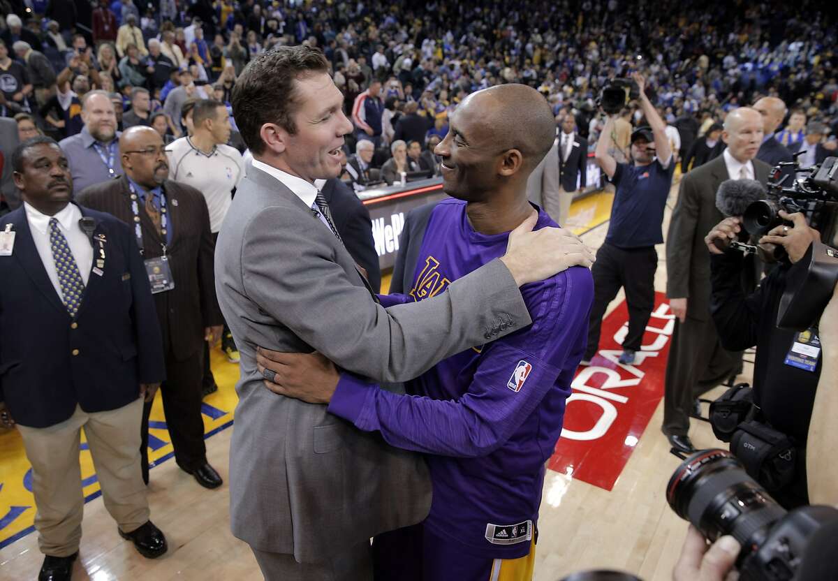 Kobe Bryant (24) hugs Luke Walton, the Warriors interim coach and Kobe's former Lakers teammate after the Golden State Warriors played against the Los Angeles Lakers at Oracle Arena in Oakland, Calif., on Thursday, January 14, 2016.