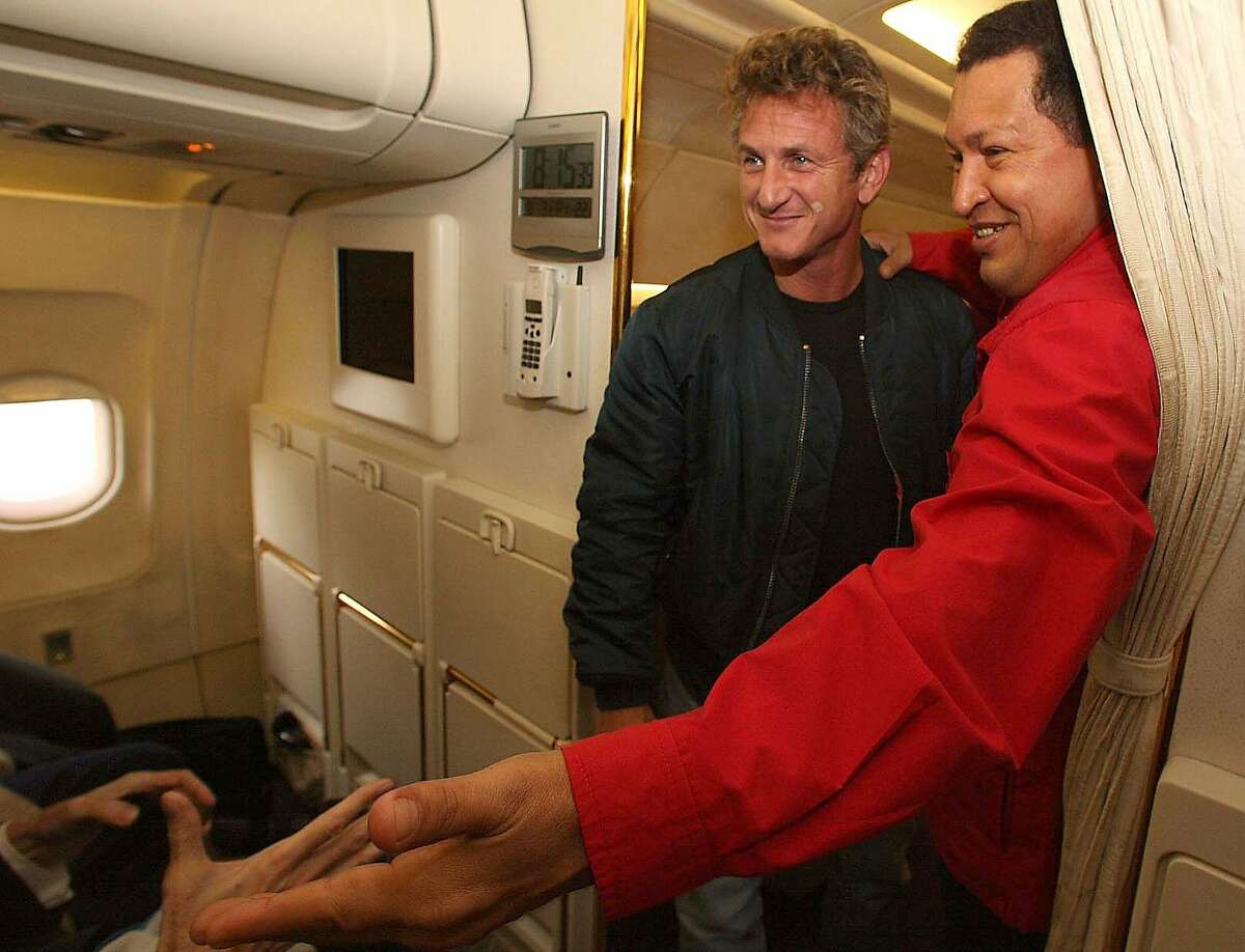 In this photo released by Miraflores Press Office, Venezuela's President Hugo Chavez, right, and the U.S. actor Sean Penn are seen during their flight to Venezuela's Tachira state, Friday, Aug 3, 2007. (AP Photo/Miraflores Press Office) ** NO SALES ** Ran on: 08-04-2007 Venezuelan President Hugo Chavez (right) and actor Sean Penn greet fellow passengers on their flight to Venezuelas Tachira state on Friday. Penn, who has also visited Iraq and Iran, said he was in the country working as a freelance journalist. I came here looking for a great country. I found a great country, Penn said.