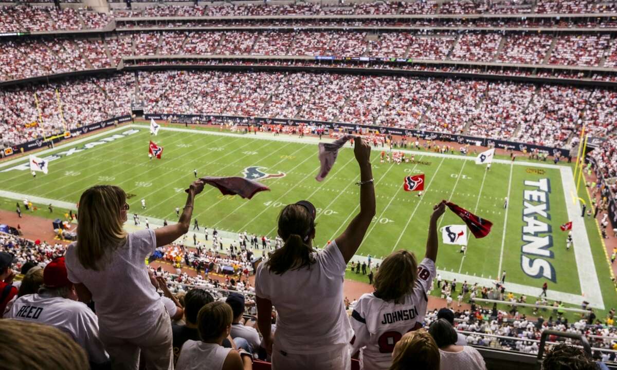 Madonna Pool, left, Shannon Reynold and Lorie Stubbs stand and cheer during a Texans game on Sept. 13, 2015. The Wi-Fi system going up at NRG Stadium will cost in excess of $6 million.