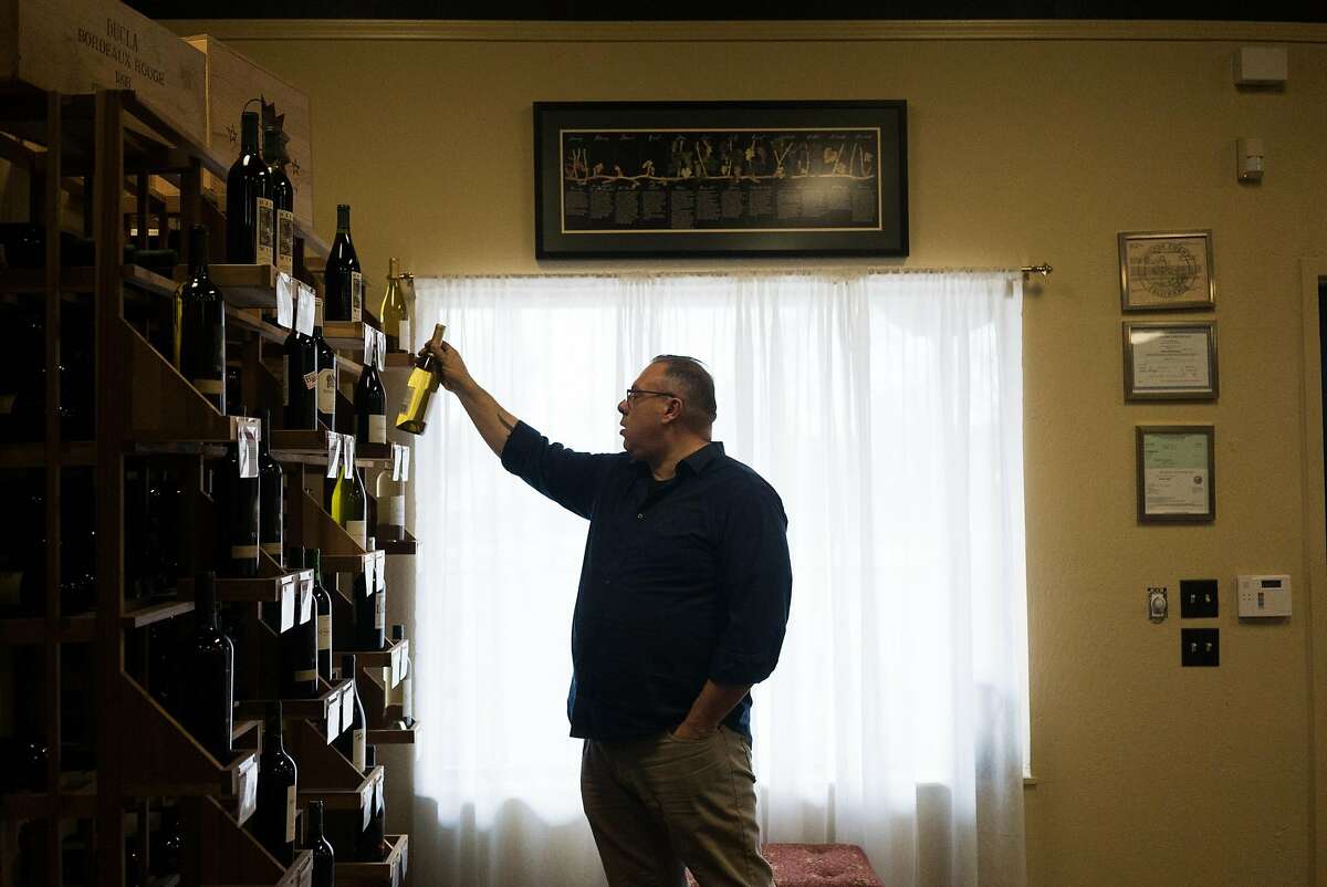 Thomas Allen takes a wine off the shelf at Amador 360 in Plymouth, Calif on Thursday, Jan. 14, 2016. Thomas Allen is a wine buyer for Taste and owner of Fate.