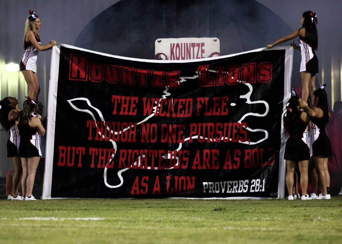 Kountze Lion's cheerleaders hold other members of their squads up to support a a larger banner at Lion's Stadium on Sept. 25. Photo provided by Denzel Seale.