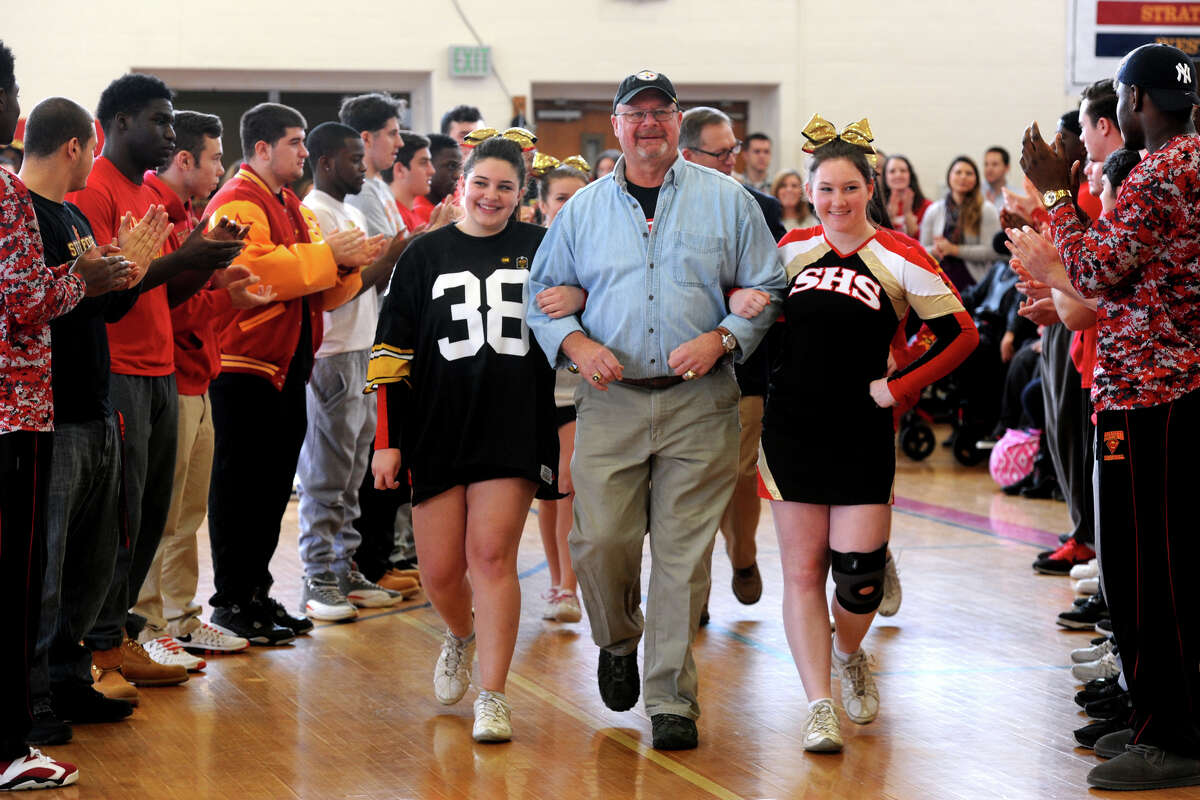Ed Bradley is escorted by cheerleaders as he is introduced at a pep rally at Stratford High School, in Stratford, Conn. Jan. 15, 2016. The school held the rally to honor both Bradley (Class of 1968) and Nick Giaquinto (Class of 1973), both of who played football at the high school and went on to win Super Bowl Championships in the NFL. Bradley won two championships with the Pittsburg Steelers, and Giaquinto won one playing for the Washington Redskins.