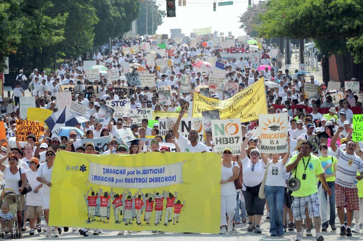 A rash of anti-immigrant laws have prompted such marches as this one in downtown Atlanta to protest Georgia's strict new immigration law in 2011. Such laws generally follow complaints that immigrants don’t assimilate and don’t learn English. These assertions have no basis in fact.