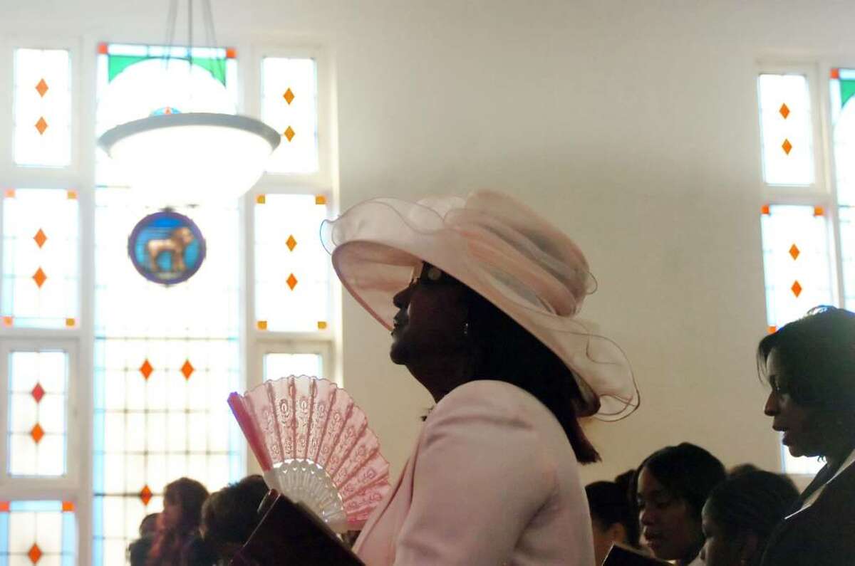 Shirley Crudup listens as the Reverend Doctor Tommie Jackson leads the Easter celebration at the Faith Tabernacle Missionary Baptist Church in Stamford, Conn., Sunday April 4, 2010.