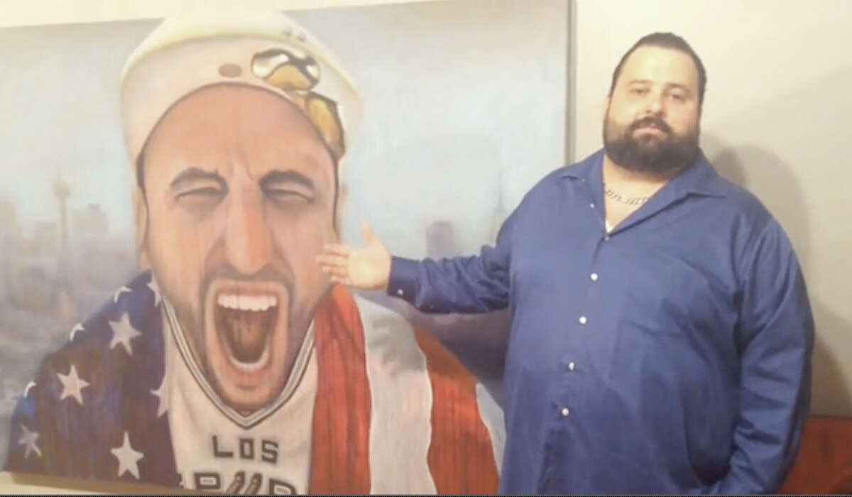 San Antonio artist Victor De La Fuente shows off his painting of Spurs star Manu Ginobili.