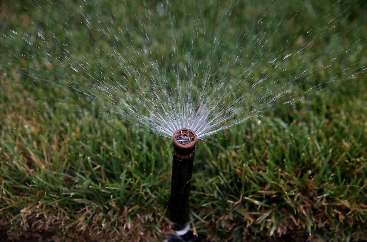A sprinkler waters a lawn on April 7, 2015 in Walnut Creek, California. As California enters its fourth year of severe drought, EBMUD and water districts throughout the state are assisting customers with finding ways to reduce water use at their homes. California residents are facing a mandatory 25 percent reduction in water use.