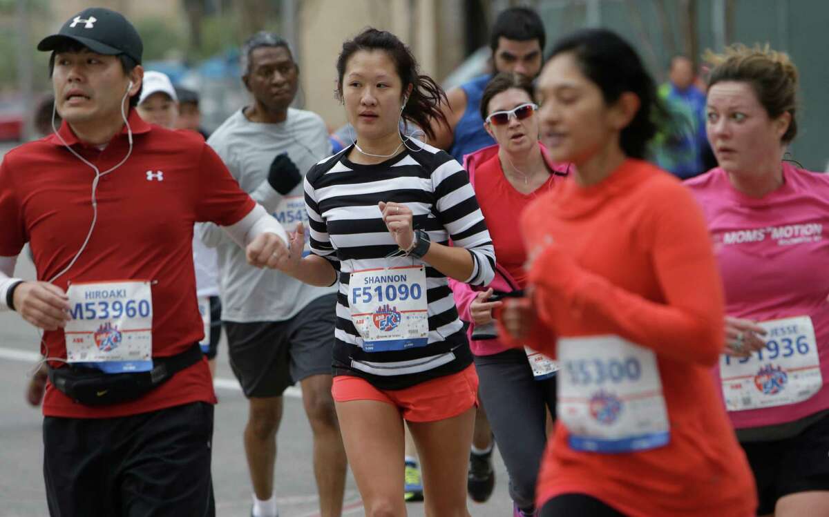 People participate in the ABB 5K in downtown Houston Saturday, Jan. 16, 2016.