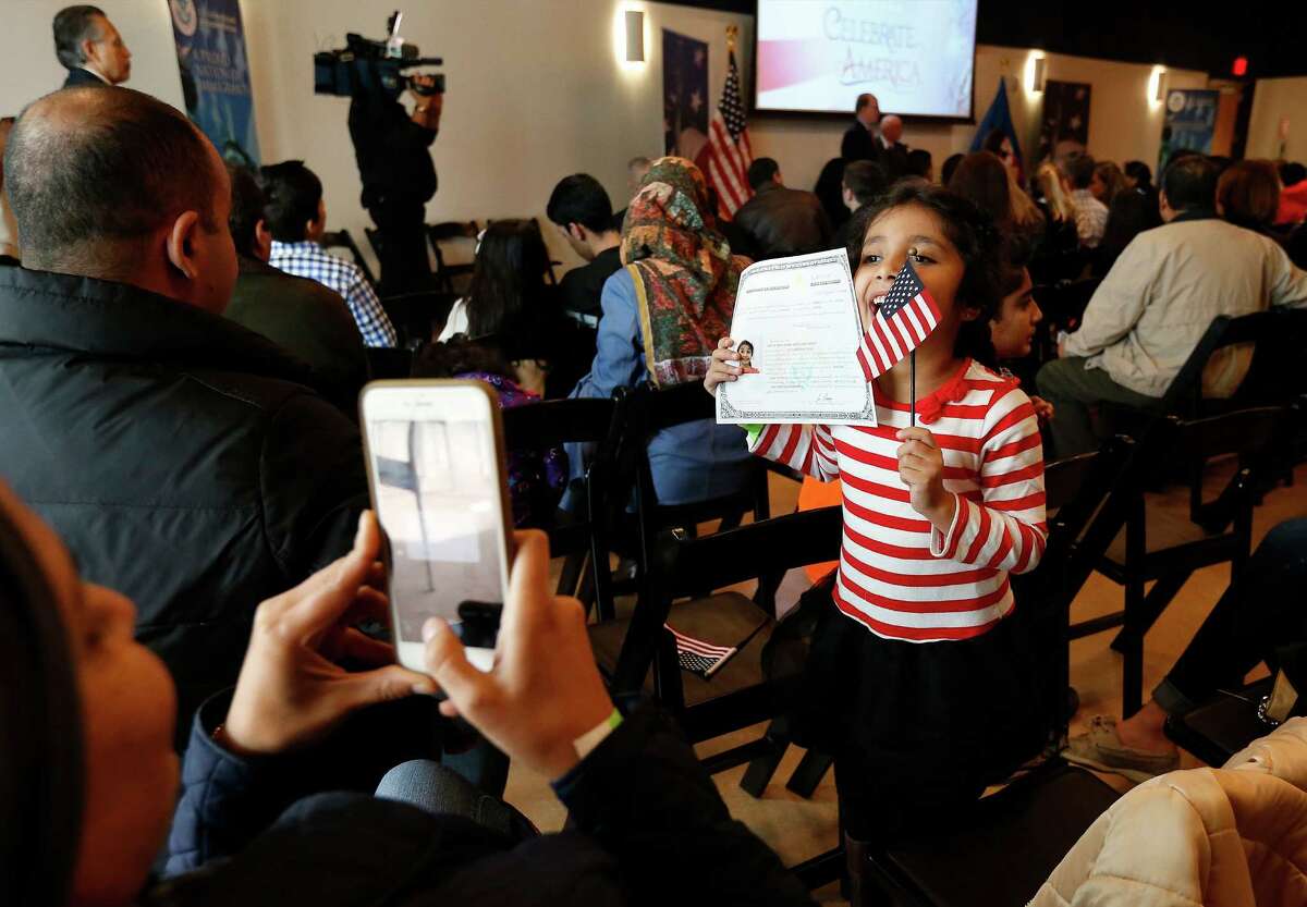 Mayar Takrity, 6, from Iraq holds her Certificate of Citizenship and U.S. flag while posing for a picture as the DoSeum hosts a ceremony in cooperation with U.S. Citizenship and Immigration Services on Saturday, Jan. 16, 2016. 52 children from 24 countries qualified for a Certificate of Citizenship as flags were waved and as guests watched a video message from President Barack Obama. Locally, Bexar County Judge Nelson Wolff spoke at the event and presented the new Americans with their certificates. Immigration services officials said they plan on holding similar events up to four times a year. The local immigration office serves 78 counties in South Central Texas. (Kin Man Hui/San Antonio Express-News)