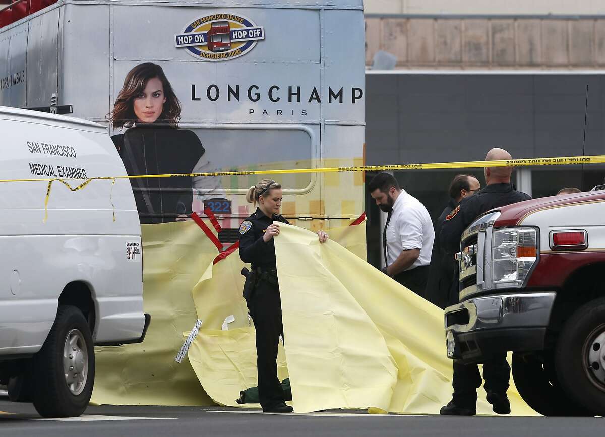 Emergency personnel secure the scene during an investigation of a fatal accident involving a tour bus and a pedestrian at Post and Divisadero streets in San Francisco, Calif. on Saturday, Jan. 16, 2016.