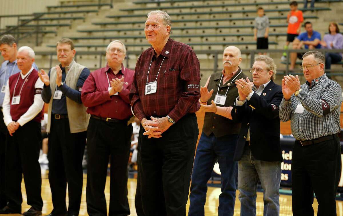 Former Marshall High School head basketball coach Ted Dockery (center) acknowledges applause from his players as Northside ISD honors members of the 1966 Marshall High School basketball team during halftime of the boys' game between Marshall and Clark at Paul Taylor Fieldhouse on Saturday, Jan. 16, 2016. 14 of the former players and Marshall alumni including Dockery were honored for their accomplishment of winning the '66 State 3A Championship in basketball. (Kin Man Hui/San Antonio Express-News)