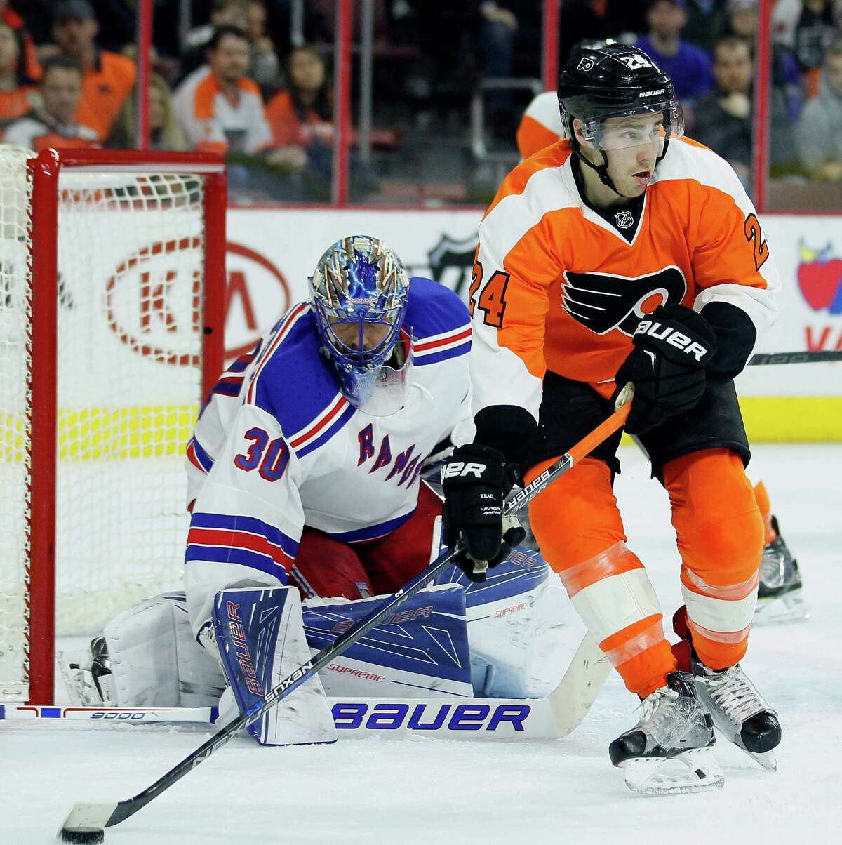 Philadelphia Flyers' Matt Read, with the puck on his stick, looks for an open man in front of the net defended by New York Rangers' Henrik Lundqvist during the second period of an NHL hockey game Saturday, Jan 16, 2016 in Philadelphia. The Rangers won 3-2 in overtime (AP Photo /Tom Mihalek) ORG XMIT: PATM111