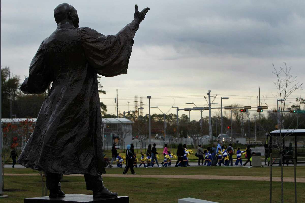 The 2016 Black Heritage Society's MLK Children's March passed in front of the statue of Martin Luther King Jr., Saturday, Jan. 16, 2016, in Houston. The march started and circled MacGregor Park.