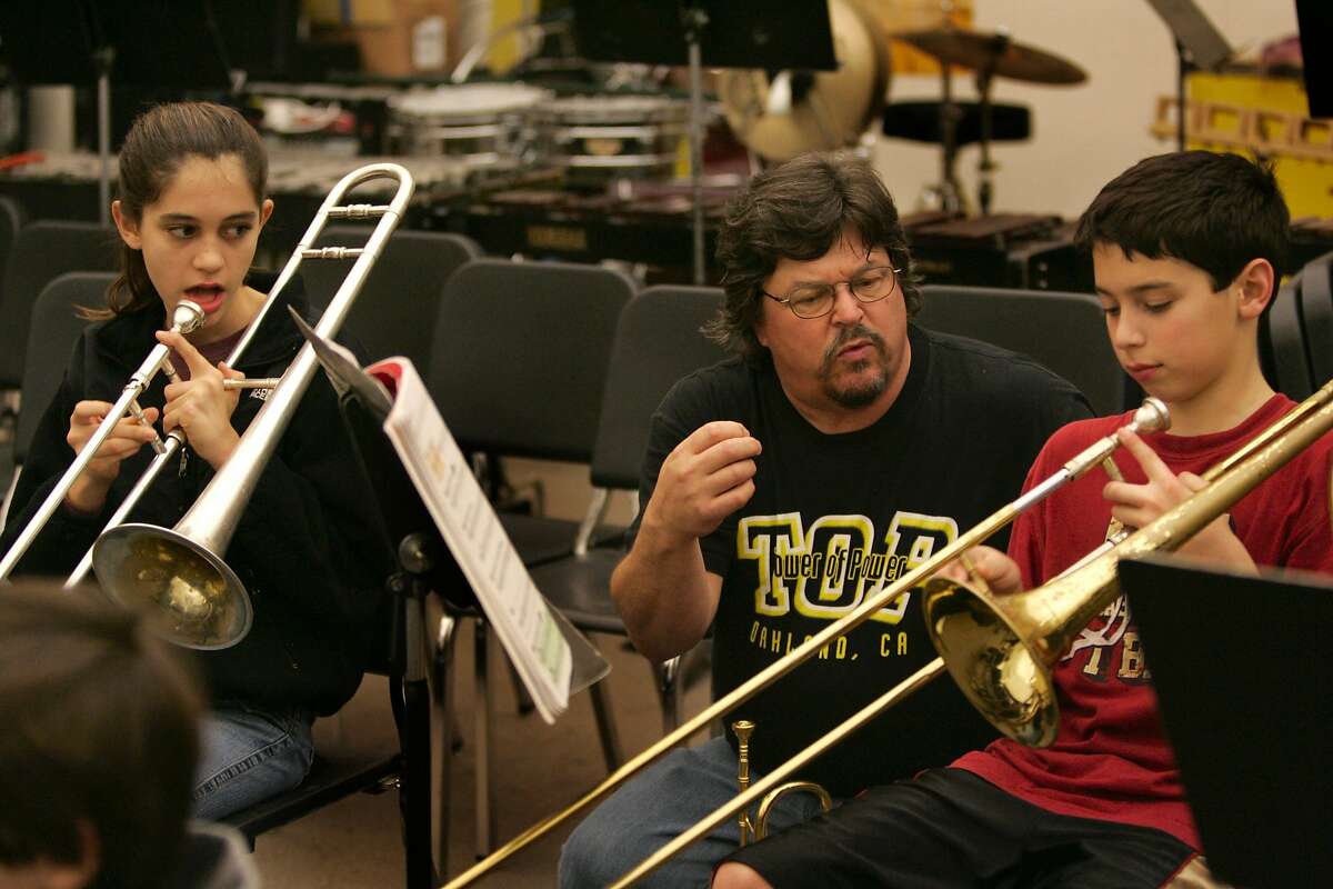 Mic Gillette former horn player with Tower of Power, works with trombone players, Maya Schechter, 7th grader, left, and Michael Leamy, 6th grader. He is assisting in the music department at Stanley Middle School in Lafayette. 