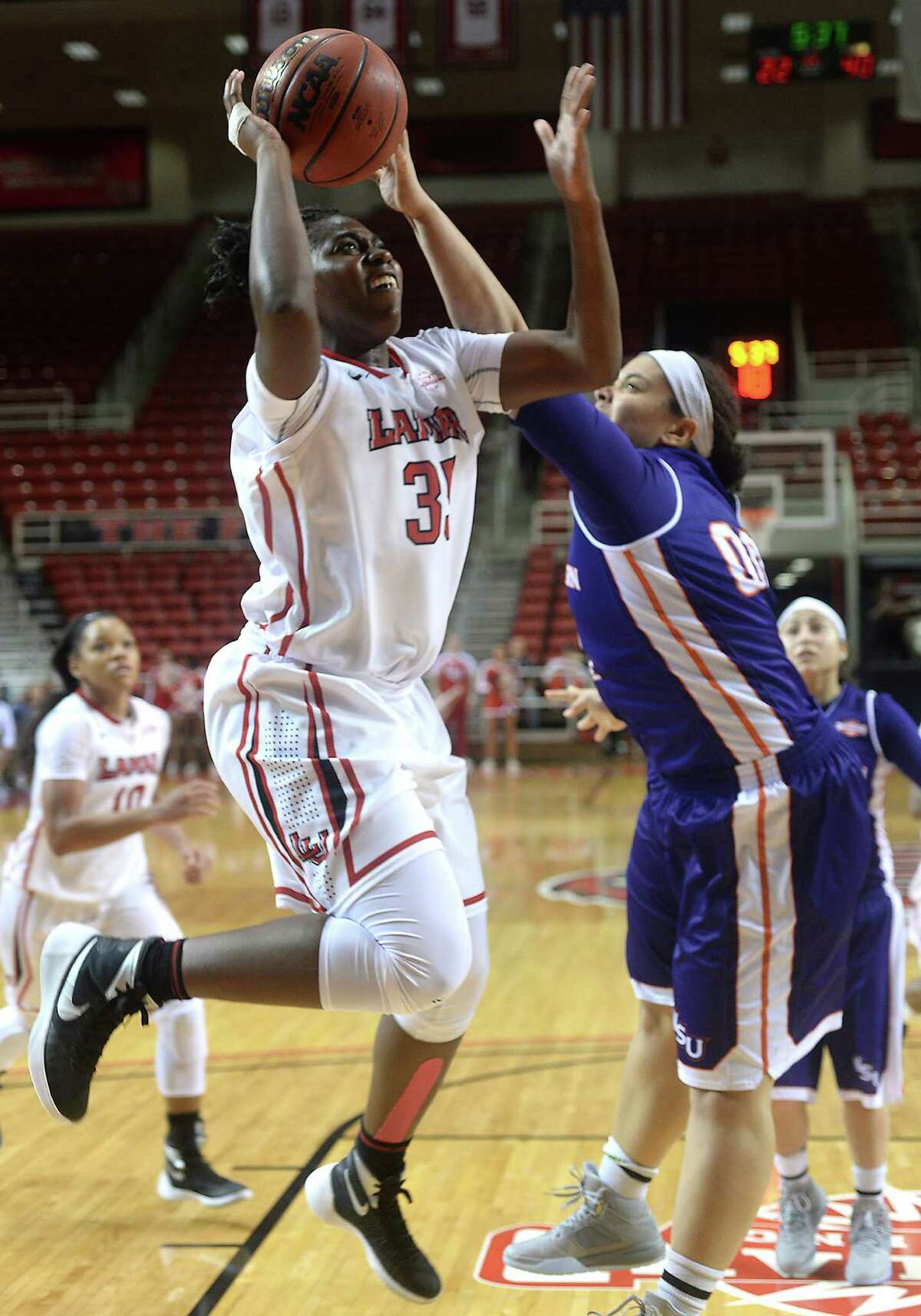 Lamar's Laka Blache looks to get past Northwestern State's Emerald Mayfield as she heads to the basket during Saturday's match-up at the Montagne Center. Photo taken Saturday, January 16, 2016 Kim Brent/The Enterprise