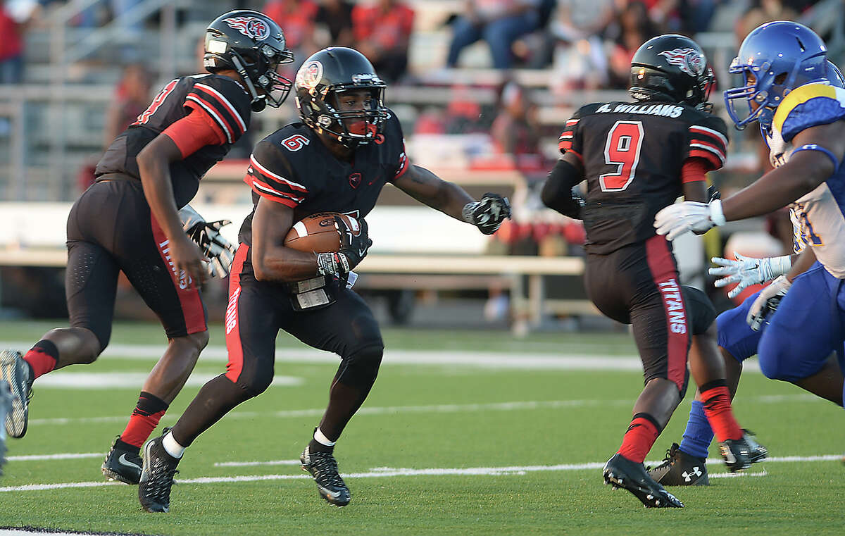 Port Arthur Memorial's Kameron Martin picks up yardage against Ozen during their Friday night match-up at Memorial Stadium in Port Arthur. Photo taken Friday, August 28, 2015 Kim Brent/The Enterprise Manditory Credit, No Sales, Mags Out, TV Out, Web: AP Members only
