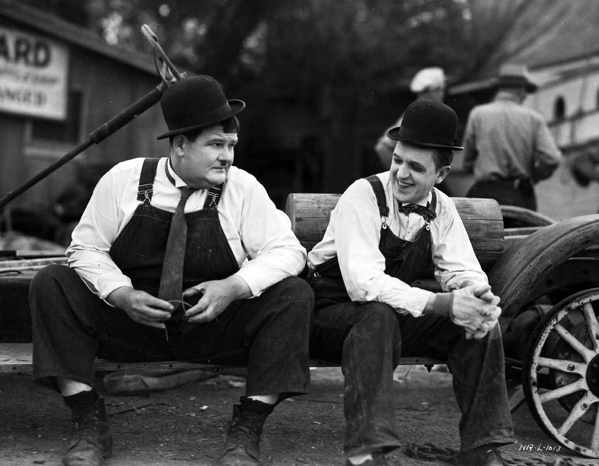 Stan Laurel and Oliver Hardy t resting in between scenes during the filming of the Hal Roach production of the 1932 film, 'Towed In A Hole', directed by George Marshall.