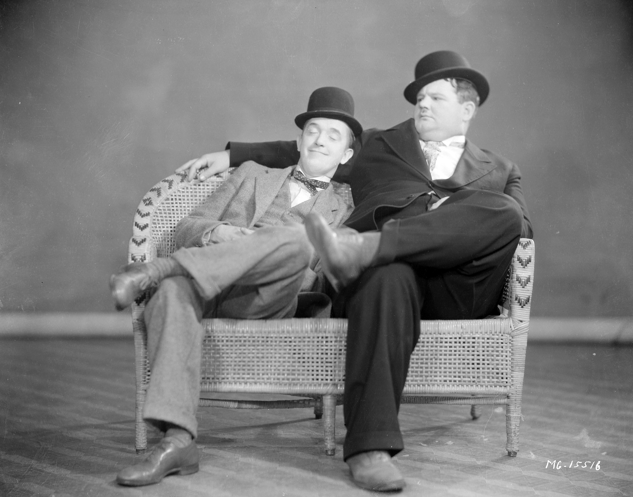 Stan Laurel enjoys blissful sleep, to the annoyance of his comedy partner Oliver Hardy, 1930.