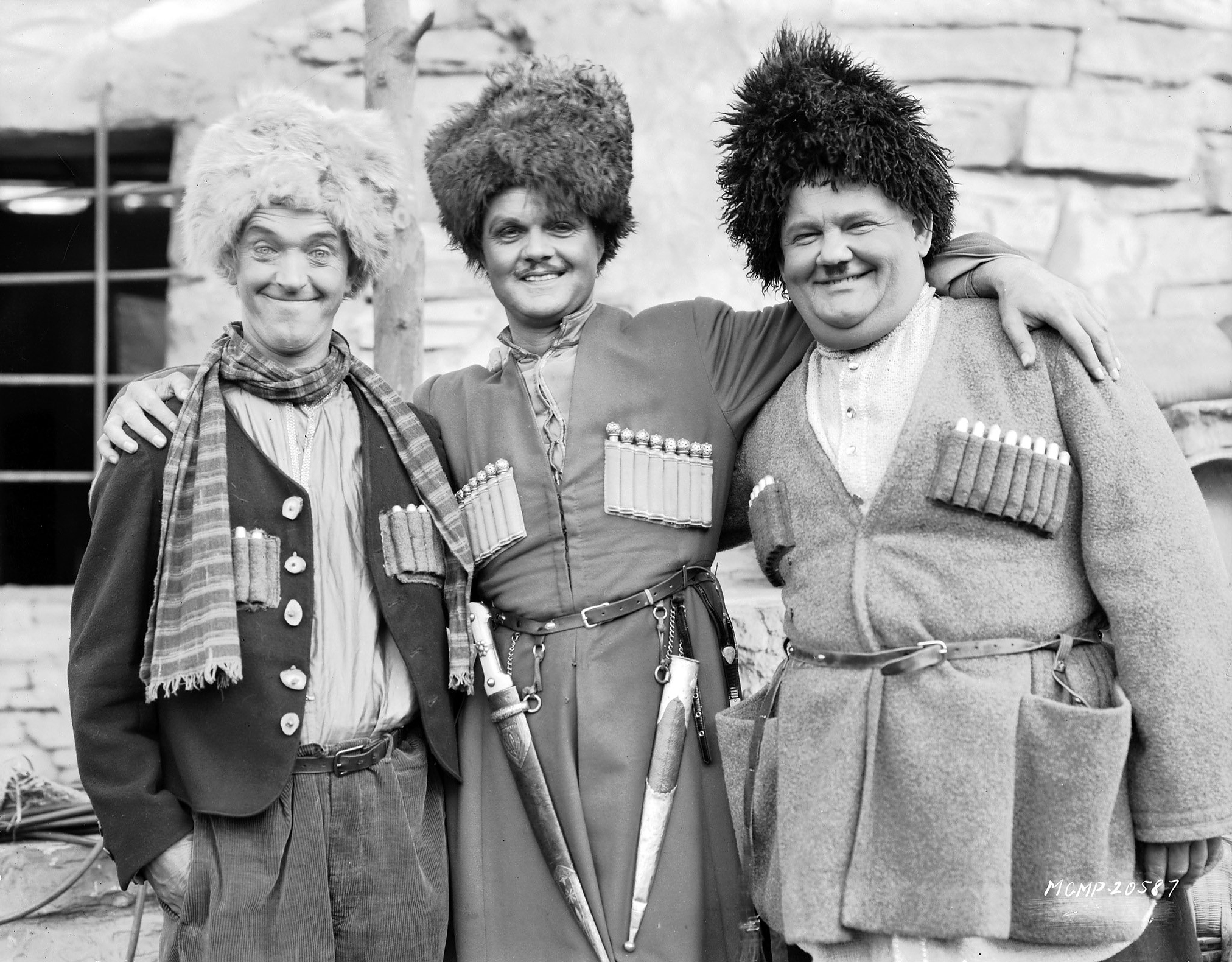 From left to right, Stan Laurel, Lawrence Tibbett and Oliver Hardy dressed as Russians for their roles in 'The Rogue Song', directed by Lionel Barrymore and Hal Roach, 1929.