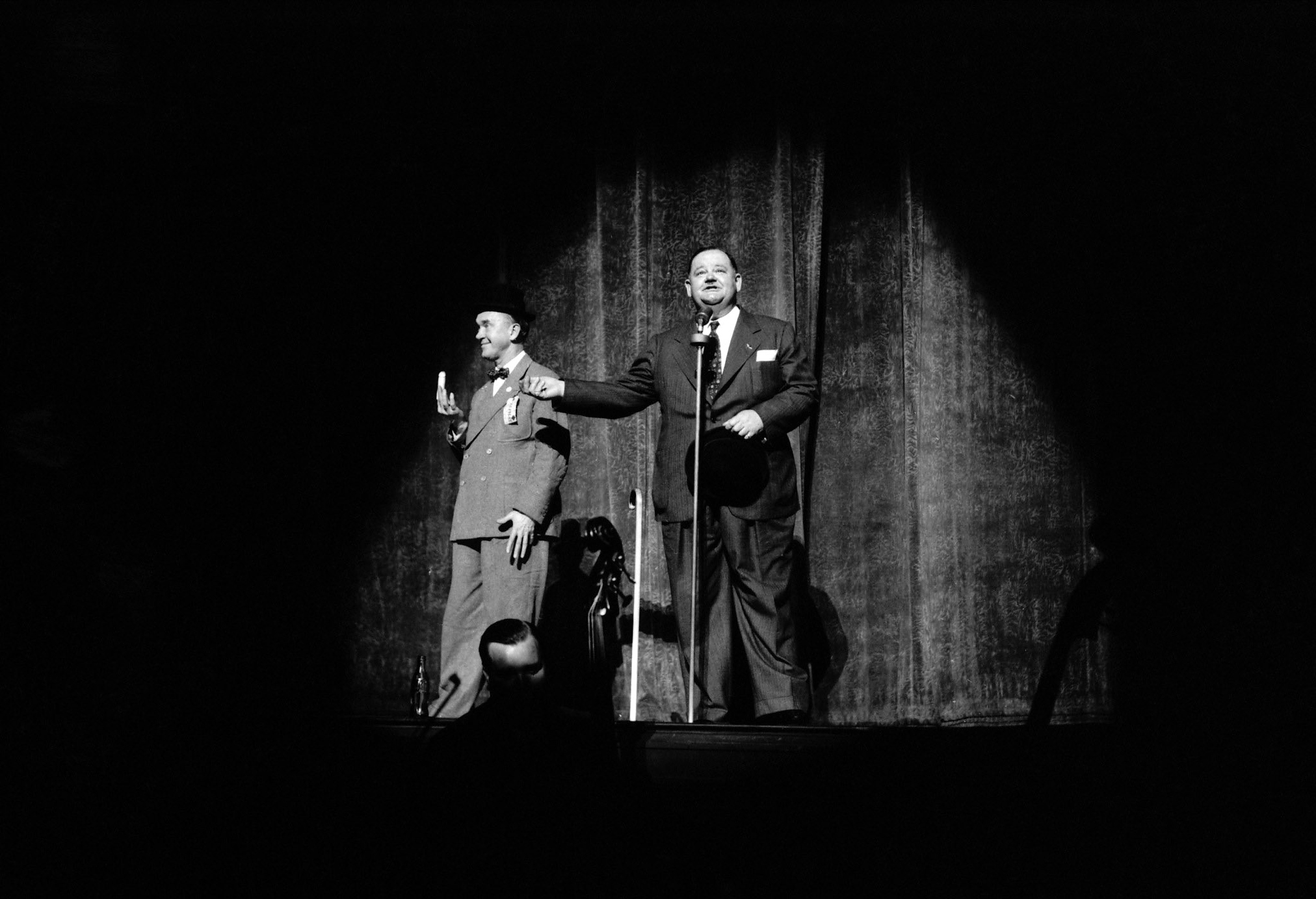 Stan Laurel and Oliver Hardy performing on stage in a Hollywood Victory Caravan show, May 1942. The Hollywood Victory Caravan was a three-week railway tour of the United States by well-known performers, to raise money for war bonds.