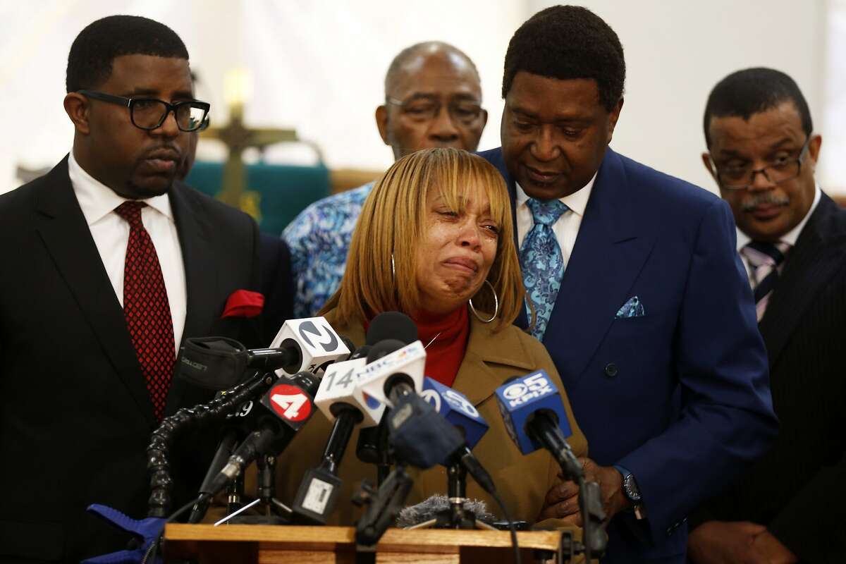Gwen Woods (center), the mother of Mario Woods, speaks through tears while being comforted by attorney John Burris (right) during a news conference at Allen Chapel in San Francisco, California, on Monday, Jan. 18, 2016.