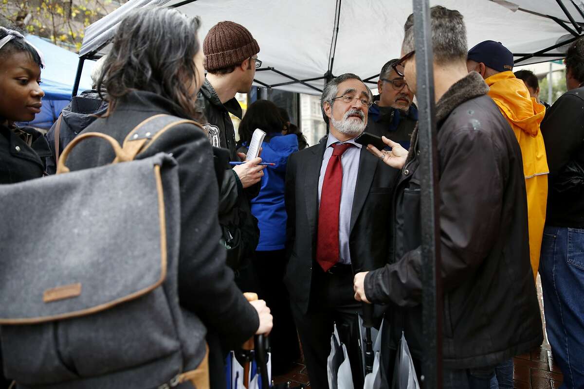 San Francisco Supervisor Aaron Peskin (center) speaks to the media at a press conference on Market Street in San Francisco, California, on Tuesday, Jan. 19, 2016.