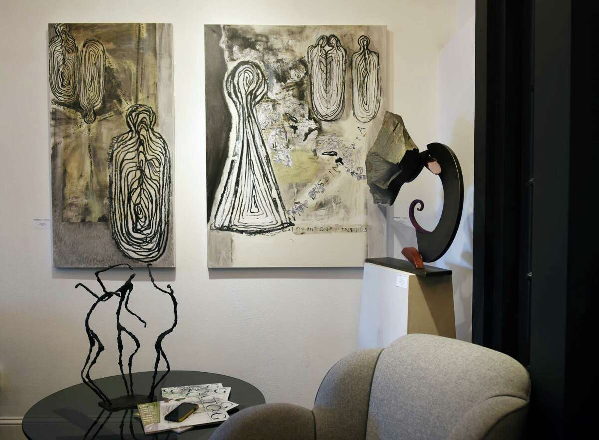 Mixed media pieces by Marisol Martinez hang above a collection of complimenting sculpture and furniture.