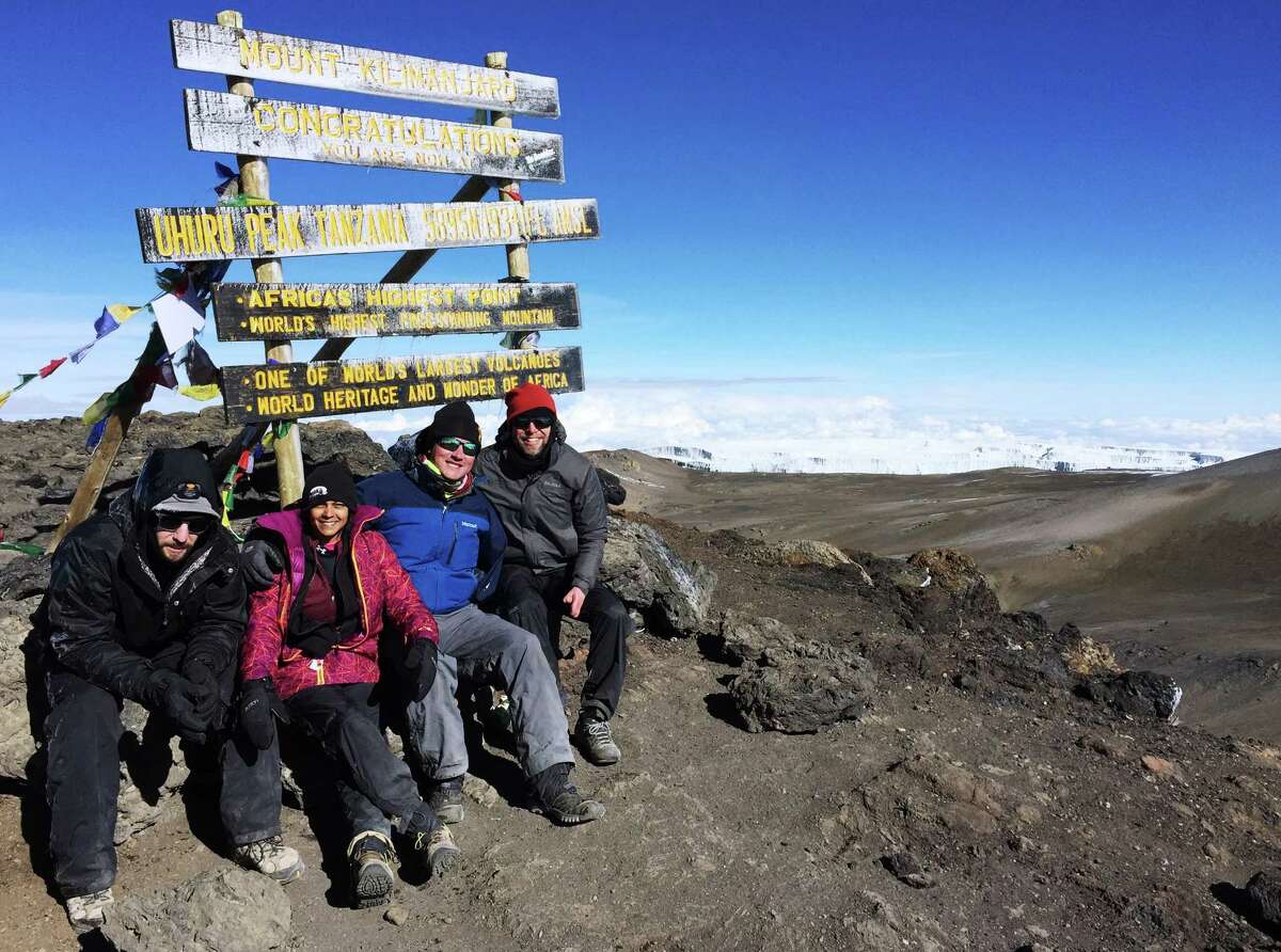 Summiting Mt. Kilimanjaro in January 2016 are (from left): Justin Pfaff, who, in addition to having lost all his toes and the fingers on right hand to frostbite, was also the team prosthetist; team leader Mona Patel; Scott Wilson, who lost his arm in an oilfield accident, and Ian Warshak, who lost both legs and all his fingers to infection.