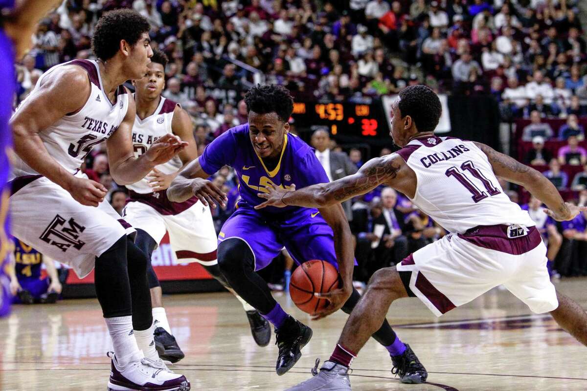 Texas A&M Aggies center Tyler Davis (34), left, and Texas A&M Aggies guard Anthony Collins (11), right, defend againt LSU Tigers guard Antonio Blakeney (2) as he heads toward the basket as Texas A&M takes on LSU Tuesday, Jan. 19, 2016, in College Station.