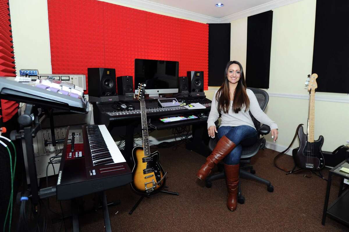 Christine Occhino, owner of The Pop Music Academy, poses for a photo in her studio. Occhino is raising funds for her new non-profit called Hope in Harmony, which brings music and music therapy to patients in area heathcare facilities.