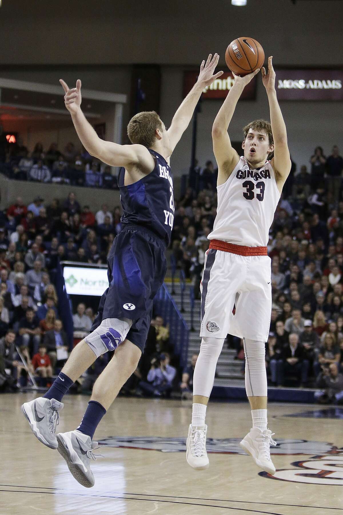 Gonzaga's Kyle Wiltjer (33) shoots against BYU's Kyle Davis during the second half of an NCAA college basketball game, Thursday, Jan. 14, 2016, in Spokane, Wash. (AP Photo/Young Kwak)