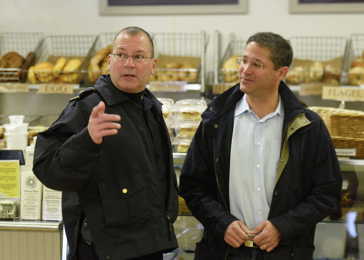 Deputy Chief Mark Marino, left, chats with Old Greenwich resident Steven Certilman during the Coffee with a Cop event at Upper Crust Bagel Co. in Old Greenwich, Conn. Wednesday, Jan. 20, 2016. The event allowed citizens to chat with Greenwich police officers in a casual setting to give them a feel for the men and women behind the uniforms.