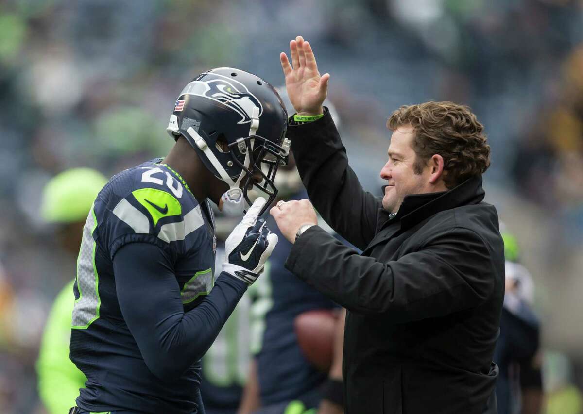 Seattle Seahawks general manager John Schneider pats defensive back Jeremy Lane on the helmet before a football game against the Pittsburgh Steelers at CenturyLink Field on November 29, 2015 in Seattle, Washington.