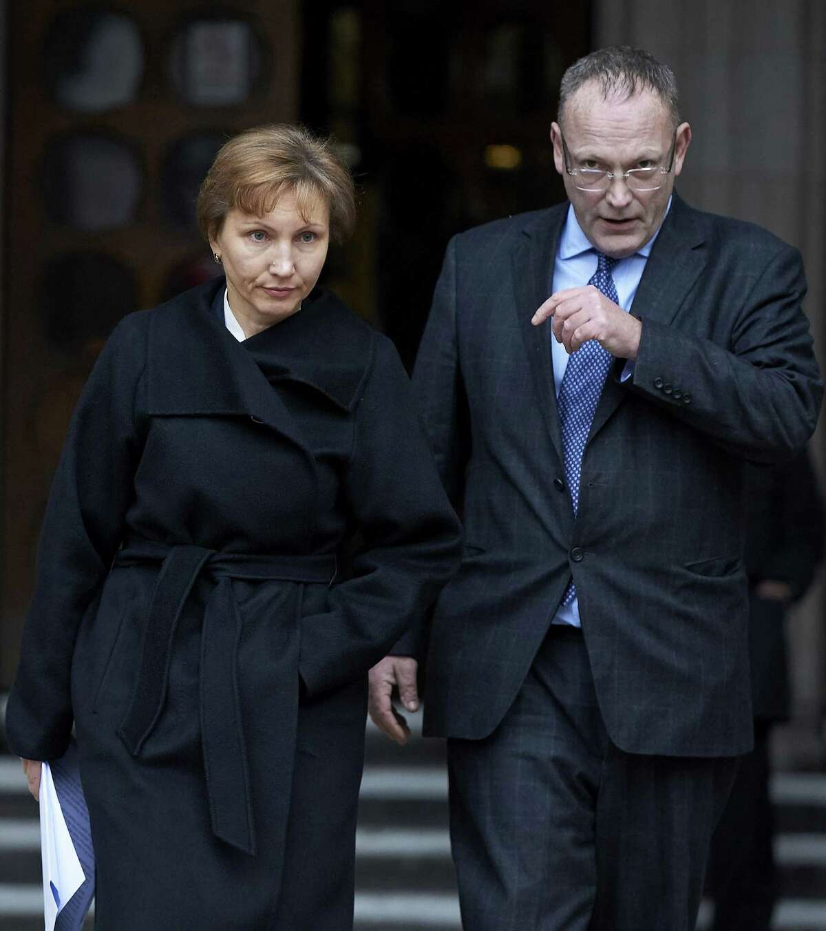 Marina Litvinenko (L), widow of Russian former spy Alexander Litvinenko, exits the Royal Courts of Justice in central London on January 21, 2016, before addressing journalists. Russian President Vladimir Putin "probably approved" the radiation poisoning of former KGB agent Alexander Litvinenko in London, a British judge said at the conclusion of a public inquiry into his agonising death. Litvinenko was allegedly poisoned at a hotel by a cup of tea laced with polonium-210 -- an extremely expensive radioactive isotope only available in closed nuclear facilities -- in a sequence of events which could have come from a Cold War thriller. AFP PHOTO / NIKLAS HALLE'NNIKLAS HALLE'N/AFP/Getty Images
