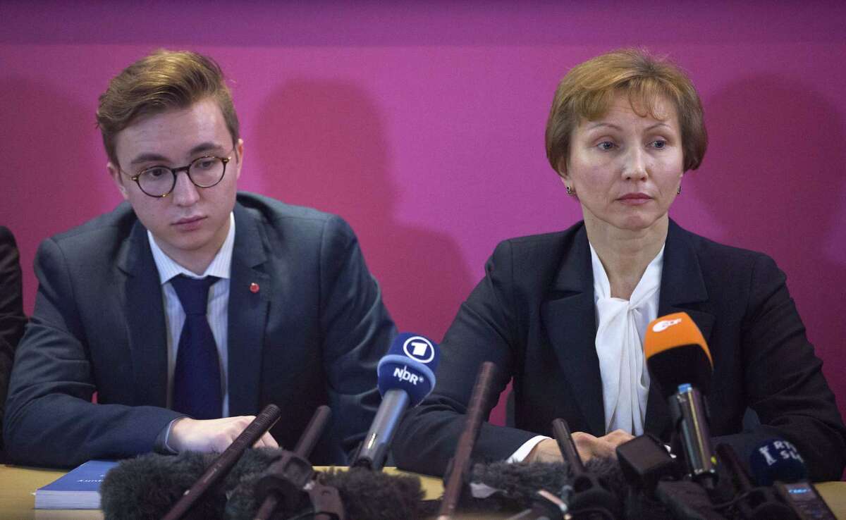 Marina Litvinenko (R), widow of ex-Russian spy Alexander Litvinenko sits by her son Anatoly during a press conference in London on Janurary 21, 2016 following the publication of the public inquiry into the death of her husband. Russian President Vladimir Putin "probably approved" the radiation poisoning of former KGB agent Alexander Litvinenko in London, a British judge said at the conclusion of a public inquiry into his agonising death. Litvinenko was allegedly poisoned at a hotel by a cup of tea laced with polonium-210 -- an extremely expensive radioactive isotope only available in closed nuclear facilities -- in a sequence of events which could have come from a Cold War thriller. AFP PHOTO / JUSTIN TALLISJUSTIN TALLIS/AFP/Getty Images