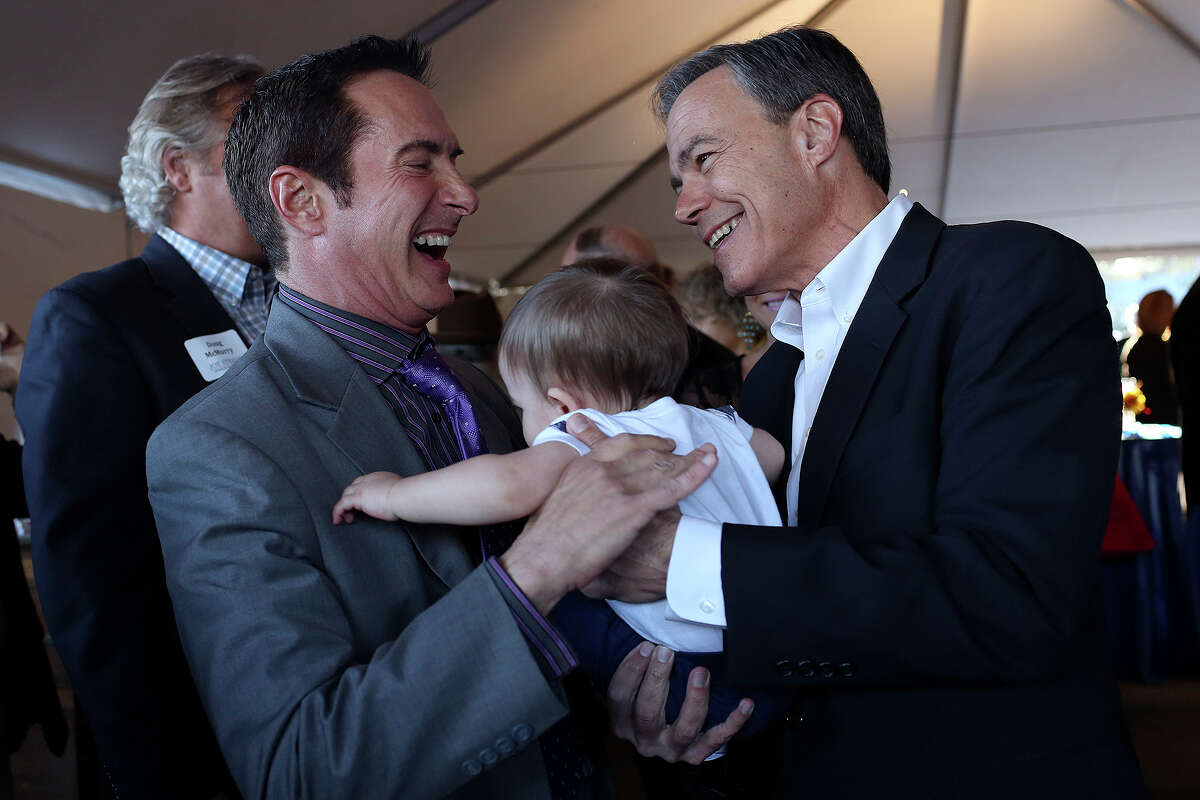 Joe Straus, Speaker of the Texas House of Representatives, hands Maury John Markson, 10 months, back to his father, Dan Markson, as Straus talks with supporters during a Campaign Cookout, formally launching his campaign, at The Barn Door in San Antonio on Thursday, Jan. 21, 2015
