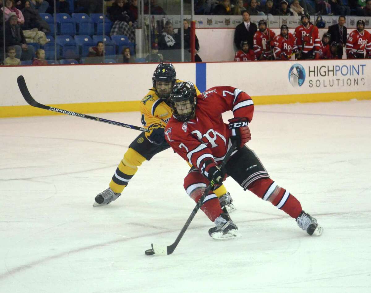 RPI senior Zach Schroeder battles for a loose puck with Quinnipiac defenseman Connor Clifton. Schroeder scored the Engineers first goal on Thursday night in Hamden. (Nick Solari/Special to the Times Union)